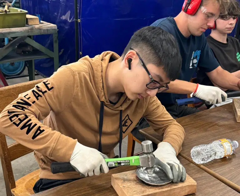 boy using hammer in a skills ready workshop